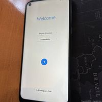 Front of LG K61 smartphone displaying welcome screen