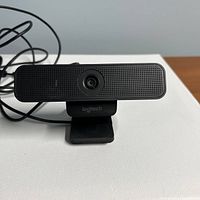 Front view of webcam on clip stand with attached USB cable