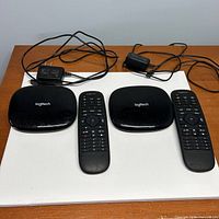 Front view showing two hubs, two remotes, two power adapters