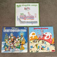 Front covers of all three LPs displayed side by side on carpet