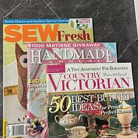 Three magazines overlapped displaying titles Sew Fresh, Handmade Annual, Country Victorian