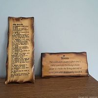 Both wooden plaques side by side on shelf