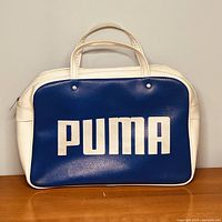 Front view showing blue panel with large PUMA logo, dual handles
