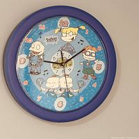 Front view of Rugrats wall clock showing characters and blue frame