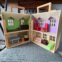 Dollhouse open showing all interior rooms and furniture pieces
