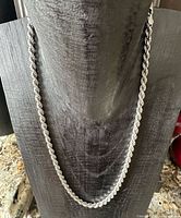 Full view of sterling silver rope chain on display bust