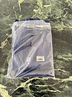 Sealed package of navy blue blackout curtains