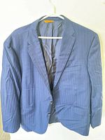 Front view of navy pinstripe blazer on hanger