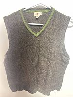 Front view of J.Crew wool vest showing V-neck, green trim, tag, overall condition