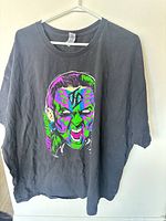 Front view of black T-shirt with Jeff Hardy graphic, shows size and design