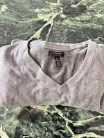 Folded Banana Republic gray V-neck sweater with size tag visible