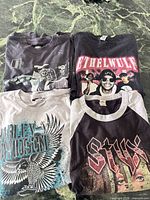 Four graphic T-shirts laid out