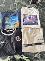 Four T-shirts laid out flat