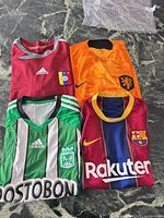Top view of all four jerseys laid out on table