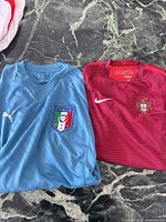 Italy and Portugal soccer jerseys laid flat showing overall design