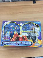 Front view of sealed retail box showing controller and light gun through window