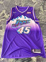 Front view of Utah Jazz Mitchell jersey showing design, number, logos and sponsor patch