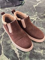Top view showing both shoes, suede finish, shearling lining, elastic gores