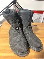 Front angled view of both boots showing quilted design and toe wear