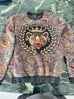 Front view of Zara jacquard sweater showing pattern and condition