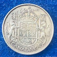 Reverse of 1945 Canadian 50-cent coin showing coat of arms, denomination and date
