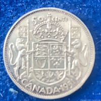 Reverse of 1951 Canadian 50 cent silver coin showing crowned shield and CANADA 1951 legend