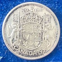 Reverse of 1958 Canadian 50 cent coin, coat of arms design