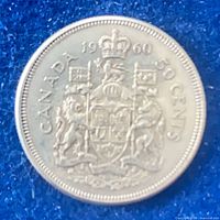 Reverse of 1960 Canadian 50-cent coin showing coat of arms and denomination