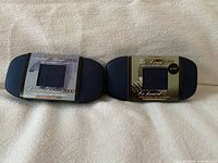 Two boxed stamp & coin sets with sleeve labels visible