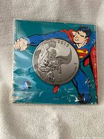Front of sealed package showing coin and Superman artwork