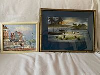 Both framed paintings side by side