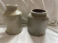 Two stoneware crocks side by side showing overall forms and colors
