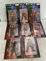 Group view of seven sealed Crimson action figures on blister cards