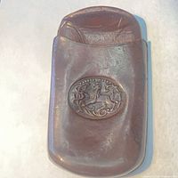 front view of cigar case showing oval lion crest
