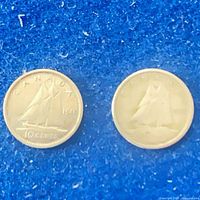Reverse sides showing Bluenose schooner design of both 10-cent coins