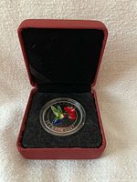 Coin in red presentation case, full view