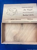 Open cigar box showing interior and engraved lid text