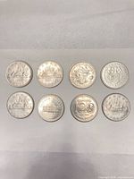 Reverse sides showing eight different designs and dates