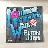 Front cover of Elton John Madman Across the Water vinyl LP with shrink and stickers
