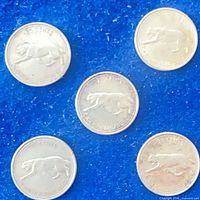 Five coins reverse side showing bobcat design