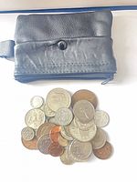 Coins and front view of purse with snap flap and zipper