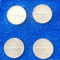 Four 1967 Canadian Centennial dimes on blue background, fish design visible