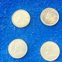 Four Canadian dimes reverse side showing Bluenose schooner