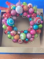 Front view of multicolor ornament wreath in box