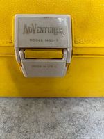 Close view of Adventurer 1499-7 latch showing brand and model