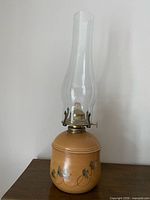 Full view of ceramic oil lamp with glass chimney