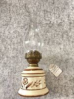 Full view of pottery oil lamp with chimney