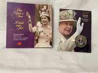 Front view of both commemorative coin sets: Once Upon a Time booklet and 80th Birthday package