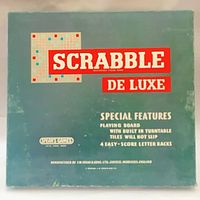 Scrabble De Luxe box front highlighting special features