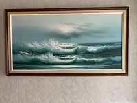 Full view of framed seascape painting on wall